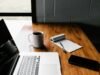 Notepad, pen, and coffee on a wooden desk prepared for a focused hourly consulting session in New York
